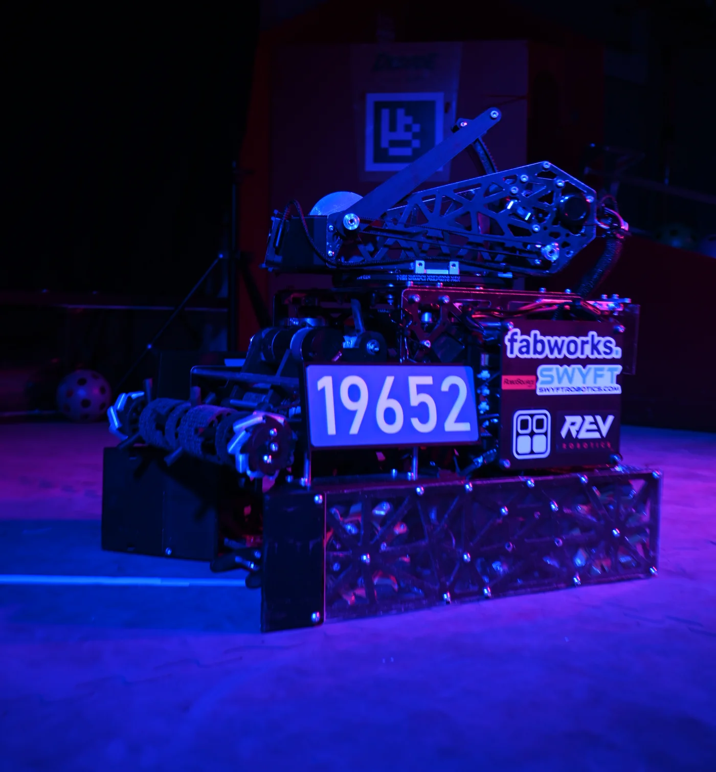 Silence, the Decode robot, lit in blue and magenta, showing the turret and shooter, the 19652 plate, and sponsor stickers