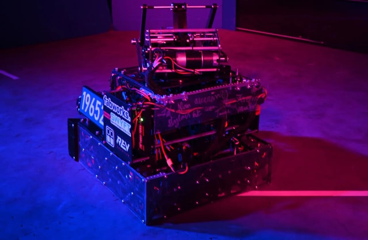 Silence from the front left at the robot reveal, lit in blue and magenta