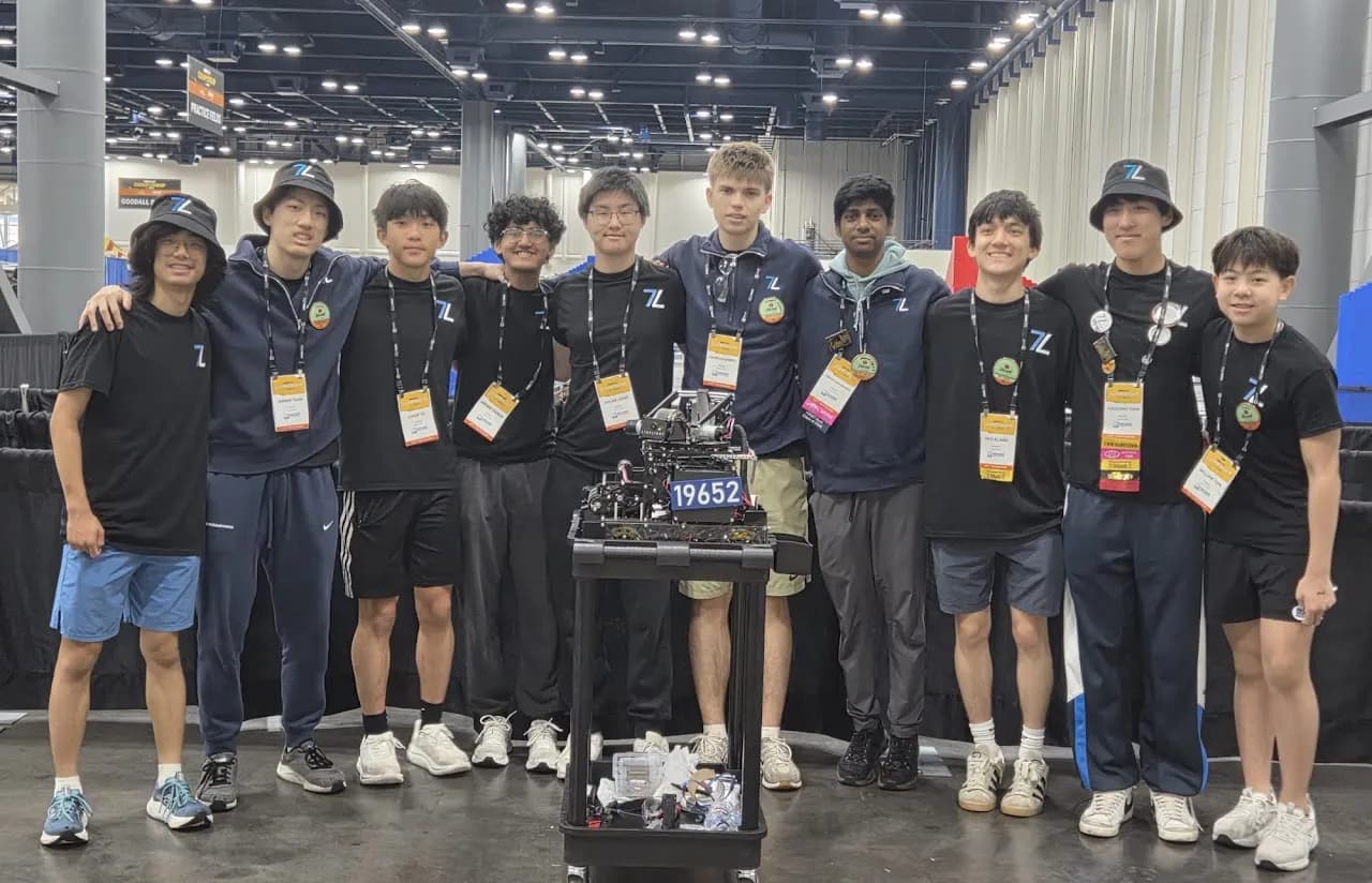 The Techineers and the robot cart in the exhibit hall at the FIRST Championship